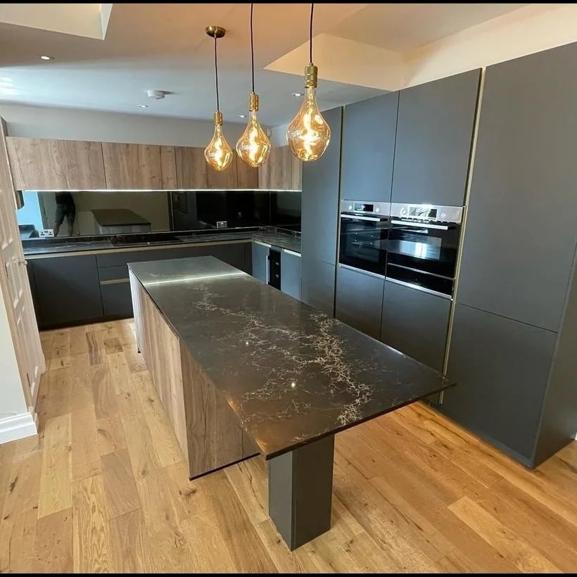 Spacious kitchen in dark tones with Vanilla Noir stone.